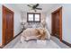 Comfortable main bedroom with neutral decor, warm wood trim, ceiling fan, and great natural light at 702 S Fanning St, Sheridan, IN 46069