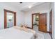 Bright and spacious main bedroom with a view of the ensuite bathroom and dining room through doorways at 702 S Fanning St, Sheridan, IN 46069