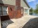 The home's backyard features a concrete patio near a water view and mature landscaping at 7023 Steinmeier W Dr, Indianapolis, IN 46220