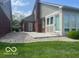 The home's backyard features a concrete patio perfect for entertaining, bordered with decorative rock and grass at 7023 Steinmeier W Dr, Indianapolis, IN 46220