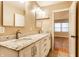 Bright bathroom with double sinks, granite counters, and a view of the bedroom at 7023 Steinmeier W Dr, Indianapolis, IN 46220