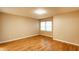 Bedroom featuring hardwood floors, neutral walls, and a large window at 7023 Steinmeier W Dr, Indianapolis, IN 46220