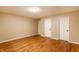 A spacious bedroom with hardwood floors and neutral paint provides a serene living space at 7023 Steinmeier W Dr, Indianapolis, IN 46220