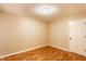 An empty bedroom with hardwood floors, neutral walls, and white trim at 7023 Steinmeier W Dr, Indianapolis, IN 46220