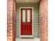 Inviting front door with decorative glass panels, surrounded by brick columns and neutral siding at 7023 Steinmeier W Dr, Indianapolis, IN 46220