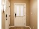 Hallway with tile flooring and doors, showcasing neutral walls and modern lighting fixtures at 7023 Steinmeier W Dr, Indianapolis, IN 46220