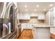 Bright kitchen features granite countertops, stainless steel appliances, white cabinets, and an island at 7023 Steinmeier W Dr, Indianapolis, IN 46220