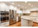 Modern kitchen with stainless steel appliances, white cabinets, granite countertops, and a kitchen island at 7023 Steinmeier W Dr, Indianapolis, IN 46220