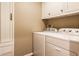 Laundry room with white cabinets and appliances at 7023 Steinmeier W Dr, Indianapolis, IN 46220