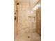 An elegant tiled shower with a glass door showcases modern fixtures and a built-in niche at 7023 Steinmeier W Dr, Indianapolis, IN 46220