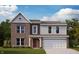 Charming two-story home featuring a brick facade, vertical siding, and an attached two-car garage at 7294 Broadview Ln, McCordsville, IN 46055