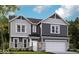 Charming two-story home with gray siding, stone accents, a two-car garage, and a well-manicured lawn at 7313 Deerberg Dr, Indianapolis, IN 46259