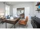 Bright home office with a large wooden desk, comfortable seating, and ample natural light at 7313 Deerberg Dr, Indianapolis, IN 46259