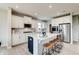 Modern kitchen features a center island with seating, stainless appliances, and bright, white cabinetry at 7313 Deerberg Dr, Indianapolis, IN 46259