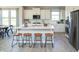 Bright kitchen with white cabinets, stainless steel appliances, a large island, and stylish bar stools at 7313 Deerberg Dr, Indianapolis, IN 46259