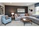 Comfortable living room with a grey sectional sofa and accent chair for watching movies at 7313 Deerberg Dr, Indianapolis, IN 46259
