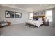Serene primary bedroom featuring a plush king bed, elegant decor, and plenty of natural light at 7313 Deerberg Dr, Indianapolis, IN 46259