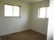 Cozy bedroom with two windows and neutral carpet at 7402 Alice Ave, Indianapolis, IN 46219