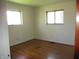 Bedroom with hardwood floors and two windows that let in natural light at 7402 Alice Ave, Indianapolis, IN 46219