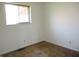This bedroom features neutral walls, a window for natural light, and wall sockets at 7402 Alice Ave, Indianapolis, IN 46219