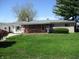 Charming single-story home with a cozy front porch and lush green lawn at 7402 Alice Ave, Indianapolis, IN 46219