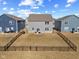 An exterior view shows a spacious, fenced backyard with a well-maintained lawn and inviting patio area at 8673 Laurelton Pl, Brownsburg, IN 46112