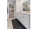 Bright bathroom featuring double sinks with granite countertops, a tiled shower, and closet access at 8673 Laurelton Pl, Brownsburg, IN 46112