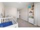 Bright and cozy Bedroom featuring ocean mural, dresser, crib, and recliner chair at 8673 Laurelton Pl, Brownsburg, IN 46112