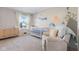 Bright and cozy Bedroom featuring ocean mural, dresser, crib, and recliner chair at 8673 Laurelton Pl, Brownsburg, IN 46112