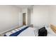 A neutrally decorated bedroom with a view into the en-suite at 8673 Laurelton Pl, Brownsburg, IN 46112
