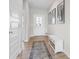 Inviting entryway with a decorative rug, bench, and natural light streaming through the front door at 8673 Laurelton Pl, Brownsburg, IN 46112