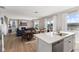 Open-concept layout with a kitchen island that blends seamlessly with the dining and living areas at 8673 Laurelton Pl, Brownsburg, IN 46112