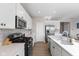 Kitchen with black stainless appliances, a backsplash, and a large center island at 8673 Laurelton Pl, Brownsburg, IN 46112