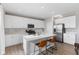 Bright kitchen featuring white cabinets, stainless steel appliances, and a center island with bar seating at 8673 Laurelton Pl, Brownsburg, IN 46112