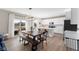 Open-concept kitchen and dining area with modern finishes, lots of natural light, and stylish furniture at 8673 Laurelton Pl, Brownsburg, IN 46112