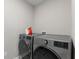 Modern laundry room featuring updated washer and dryer with storage at 8673 Laurelton Pl, Brownsburg, IN 46112