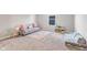 Cozy living room featuring a comfortable couch, stylish rug, and play area at 8673 Laurelton Pl, Brownsburg, IN 46112