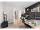 Bright home office featuring a work space with shelving and views to a hallway through double doors at 8673 Laurelton Pl, Brownsburg, IN 46112