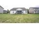 View of the backyard with a screened in porch at 8748 N Autumnview Dr, McCordsville, IN 46055
