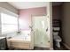 Bright bathroom with a glass shower, a separate soaking tub, and decorative plants at 8748 N Autumnview Dr, McCordsville, IN 46055