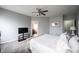 Bedroom with gray walls, carpet, ceiling fan and view into the bathroom and the walk-in closet at 8748 N Autumnview Dr, McCordsville, IN 46055
