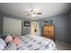 Bedroom with gray walls, ceiling fan, closet, and small dresser with a lamp at 8748 N Autumnview Dr, McCordsville, IN 46055