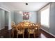 Elegant dining room with a modern light fixture, wooden table and chairs, and a bright window at 8748 N Autumnview Dr, McCordsville, IN 46055