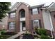 Close-up view of a brick home showcasing an arched window above the front door and well-maintained landscaping at 8748 N Autumnview Dr, McCordsville, IN 46055