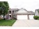 Charming two-story brick home with a three-car garage, manicured lawn, and tasteful landscaping at 8748 N Autumnview Dr, McCordsville, IN 46055