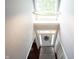 Bright foyer featuring a chandelier, front door with wreath, and hardwood floors at 8748 N Autumnview Dr, McCordsville, IN 46055