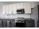 Kitchen with stainless appliances, granite counters, and white backsplash at 8748 N Autumnview Dr, McCordsville, IN 46055