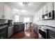 Bright kitchen with stainless appliances, granite counters and views into the dining room at 8748 N Autumnview Dr, McCordsville, IN 46055