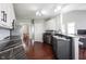 Galley style kitchen with stainless appliances, granite countertops, and views into the dining room at 8748 N Autumnview Dr, McCordsville, IN 46055