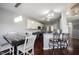Open kitchen with stainless steel appliances, granite countertops and dark wood floors at 8748 N Autumnview Dr, McCordsville, IN 46055